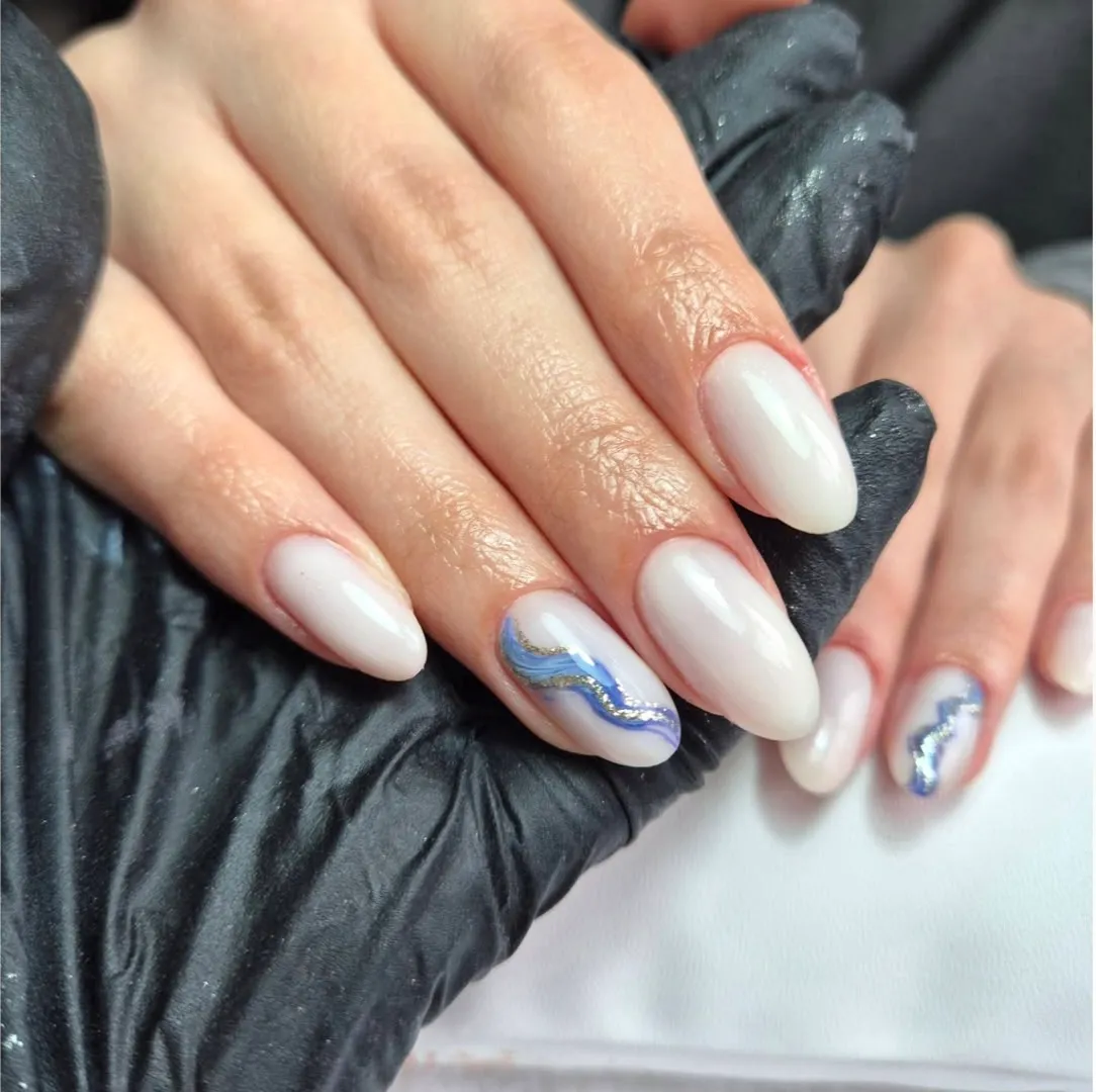 Milky white almond nails with a blue chrome swirl